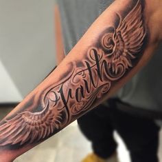 a man with a tattoo on his arm that has the word faith written in it