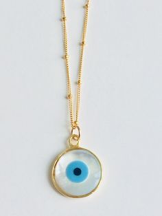 "Shell Evil Eye Necklace. This is a Shell evil eye necklace on a 16\" inch satellite chain. The white of the pendant reminds me of the white washed walls of buildings on the Greek islands. The evil eye is said to protect it's wearer from evil. Be it bad people or dangerous situations. I love mine and wear it often. 💫💫" White Spiritual Charm Necklace With Round Pendant, Spiritual White Charm Necklace With Round Pendant, White Spiritual Round Pendant Charm Necklace, White Evil Eye Round Pendant Necklace, White Round Pendant Necklace With Evil Eye, White Evil Eye Jewelry, Dangerous Situations, Jewelry Evil Eye, Bad People