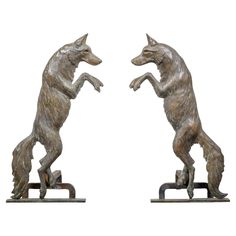 A pair of American Turn of the Century bronze andirons from circa 1900 depicting two wolves standing on their hind legs. This striking pair of American Turn of the Century bronze andirons from circa 1900 is a captivating representation of two wolves, each artfully crafted to stand on their hind legs, facing each other as if caught in a moment of interaction. The detailed casting highlights the wolves' muscular forms and expressive features, enhanced by subtle accents of verdigris patina that add Fireplace Andirons, Two Wolves, Ski House, Wild Spirit, Fireplace Tools, Garden Elements, Rustic Cabin, Fireplace Accessories, Early 20th Century