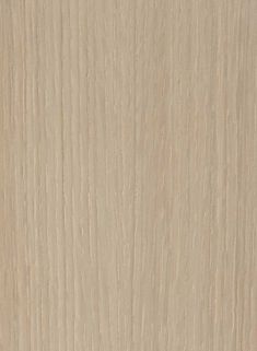 a close up view of the grained surface of a wood paneling material that is light brown