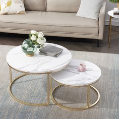 two tables sitting on top of a rug in front of a couch and coffee table