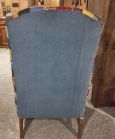 a blue chair sitting on top of a carpet covered floor