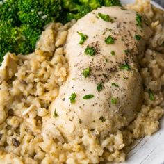 a white plate topped with chicken and rice next to broccoli