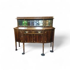 an old fashioned sideboard with glass doors on the top and bottom shelf, against a white background