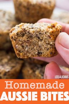 someone holding up a muffin in front of some other muffins with the words homemade aussie bites on it