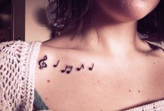 a woman with musical notes tattooed on her chest