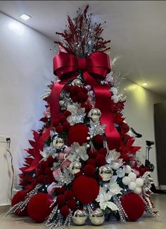 a christmas tree decorated with red and silver ornaments