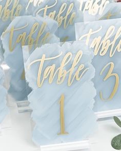 blue and gold wedding table numbers on white acrylic