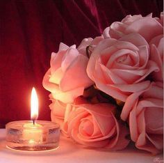 a candle and some flowers on a table