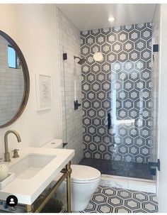 a white toilet sitting under a bathroom mirror next to a walk in shower with glass doors