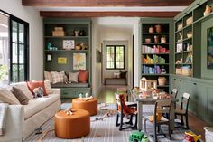 a living room filled with furniture and bookshelves