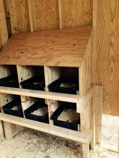 the inside of a chicken coop with several bins