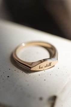 Thin gold signet ring with 'be still' engraving Minimalist Engraved Ring For Everyday Wear, Everyday Yellow Gold Signet Ring With Engraving Option, Yellow Gold Signet Ring With Engraving Option For Everyday, Minimalist 14k Gold Ring With Engraving Option, 14k Gold Signet Ring With Engraving Option For Everyday, Minimalist Open Signet Ring With Engraving Option, Everyday 14k Gold Signet Ring With Engraving Option, Everyday Yellow Gold Engraved Ring, Everyday Elegant Personalized Engraved Ring