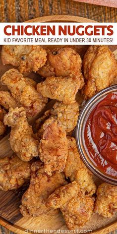 chicken nuggets with ketchup in a bowl on a wooden platter