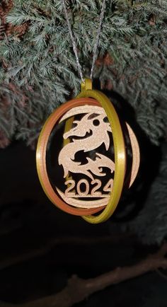 a wooden ornament hanging from a tree