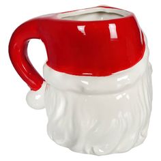 a red and white ceramic santa claus mug