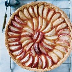 an apple pie is on a cooling rack