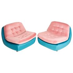 two pink and blue chairs sitting next to each other on top of a white floor