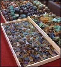 two boxes filled with different types of glass pebbles