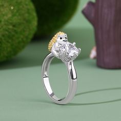 Now tell me who doesn't just love hedgehogs? So prickly when they are curled up and so cute when they uncurl in your hand exposing their shy pointy faces. Crafted in sterling silver, this ring features a shimmering round-cut stone hugged by a cute hedgehog. Remember the Queen of Hearts in "Alice's Adventures in Wonderland"? And how she used hedgehogs for croquet balls? And how they scampered away much to the Queen's chagrin. Well, this hedgehog promises not to scamper away. You will find more adorable and creative designs in our Hug Me® collection.Carat Weight: 2.65 ctStone Size: 7 mmStone Type: Jeulia® StoneNumber of Stones: 1 Stone Shape: RoundStone Color: Diamond WhiteCarat Weight: 0.454 ctStone Size: 0.8 mmStone Type: Jeulia® StoneNumber of Stones: 30 Stone Shape: RoundStone Color: Dia Croquet Balls, Hedgehog Necklace, Hedgehog Gifts, The Queen Of Hearts, Alice's Adventures In Wonderland, Cute Hedgehog, Animal Rings, Adventures In Wonderland, Hedgehogs