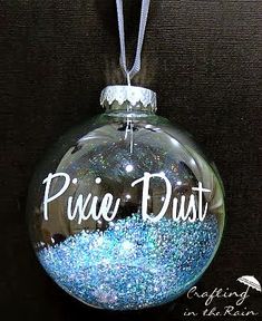 a glass ornament with the word prince dust on it and blue glitter inside