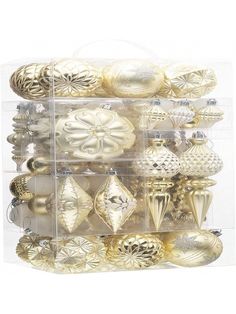 a clear box filled with lots of gold ornaments