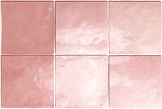 a pink tile wall with several different shades of pink and white tiles on the floor