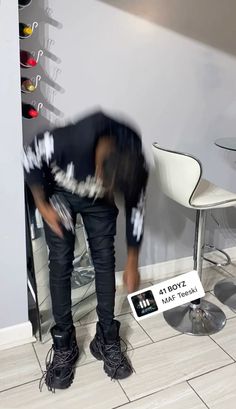 a man standing in front of a hair salon chair with his head on the counter