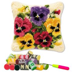 a pillow with crayons and flowers on it