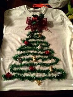 a white shirt with a christmas tree on it