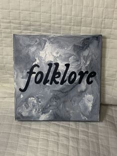 a black and white painting with the word folklore on it