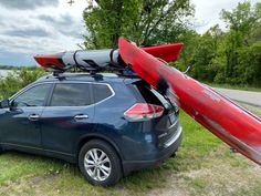 a car with kayaks strapped to the roof