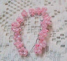 a pink beaded bracelet on a white cloth