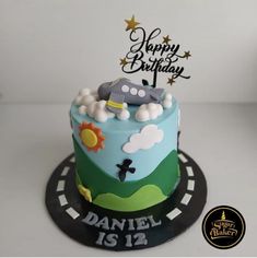 a birthday cake is decorated with cars and stars