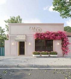 a pink building with flowers on the outside