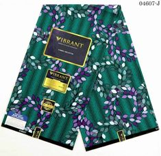 a close up of a green and purple patterned shorts with gold foil on the side