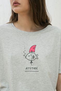 a woman wearing a t - shirt that says attitude