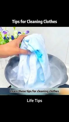 a person is cleaning clothes in a pan