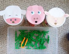 three little piggies are sitting on the floor next to some scissors and green grass