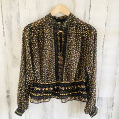 Nwot Free People Blouse Chiffon Top Beaded High Neck Black Floral Print Xs Sheer Keyhole In Front Elastic Waist Black / Yellow / Purple Approximate Measurements: Bust: 18" From Underarm To Underarm Waist: 14" Across The Front, Stretches To 20" Length: 18” Tag May Have Been Marked To Prevent Store Returns And/Or May Have Been Partially Cut Or Detached. Price Tags May Have Stickers / Markings Or May Have Peeled Off Or Been Cut. Hanger Straps Might Be Damaged Due To Items Having Been In A Retail En Elegant Yellow Tops With Floral Print, Flowy Yellow Blouse For Fall, Elegant Yellow Top With Floral Print, Party Yellow Blouse With Floral Print, Yellow Floral Print Party Blouse, Black Bohemian Unstitched Blouse Piece, Bohemian Unstitched Black Blouse Piece, Black Floral Print Chiffon Blouse, Black Sheer Top Free People