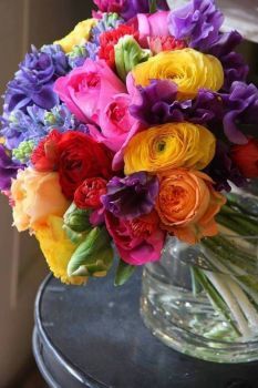 a vase filled with colorful flowers on top of a table