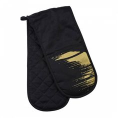 a black oven mitt with gold paint splattered on the front and side