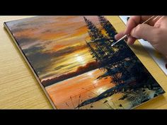 someone is painting a sunset scene on a canvas