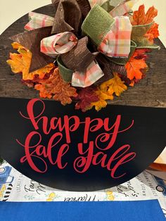 a sign that says, happy fall y'all with leaves and bows on it