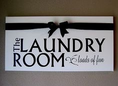 the laundry room sign is hanging on the wall