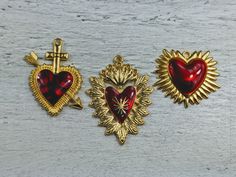 Love these new charms gold plating over metal alloy red epoxy heart  listing is for 2 charms lead free  1.5mm hole bail at top measurements including bail: left heart: 39x38mm middle heart: 44x33mm right heart: 29x33mm Flaming Sacred Heart, Nickel-free Pendant Charms For Valentine's Day, Gold Heart Charms For Valentine's Day, Gold Heart Charm For Valentine's Day, Sacred Heart Aesthetic, Valentine's Day Heart Pendant Charms, Valentine's Day Gold Heart Charm, Red Heart-shaped Charm Jewelry, Red Charms For Valentine's Day