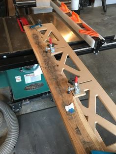 a table sawing machine is being used to cut planks in order to make a bench