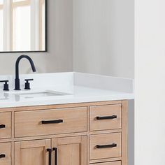 a bathroom sink with two faucets and a mirror on the wall above it