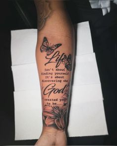 a person's arm with a quote on it and some butterflies flying around them