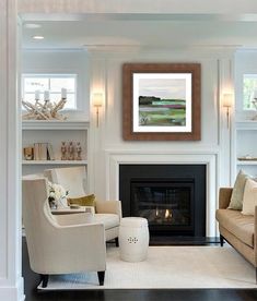 a living room filled with furniture and a fire place in the middle of a room